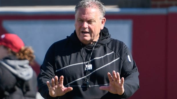 Arkansas coach Sam Pittman works with his players during spring practice in Fayetteville.